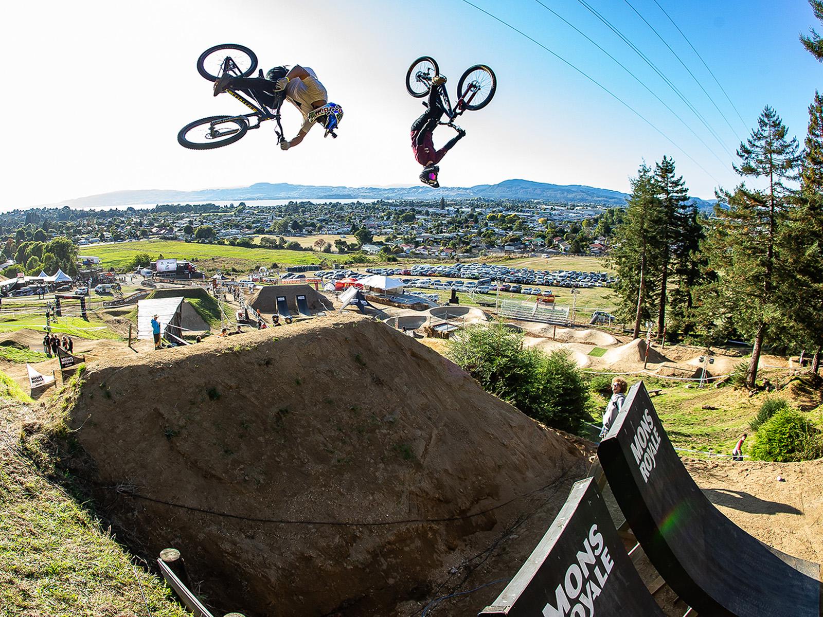 Mountain bike riders in the air doing a flip
